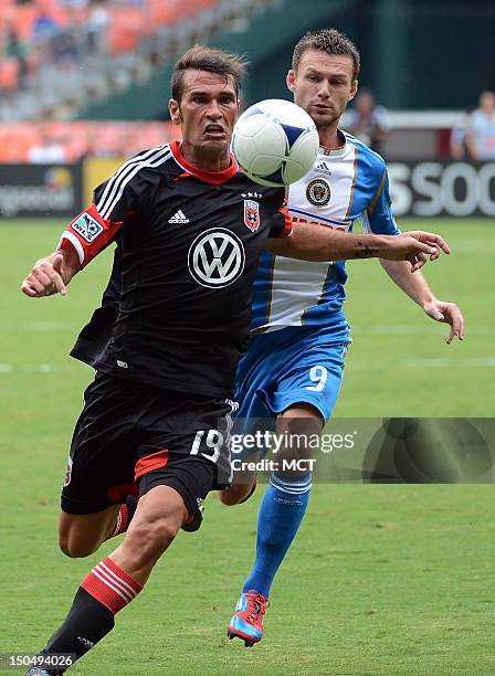 United defender Emiliano Dudar chases down a ball against Philadelphia Union forward Jack McInerney during first-half action at RFK Stadium in...