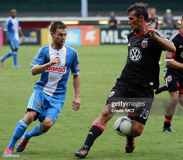 United defender Emiliano Dudar deflects an attempt by Philadelphia Union forward Jack McInerney to slip past him with the ball during first-half...