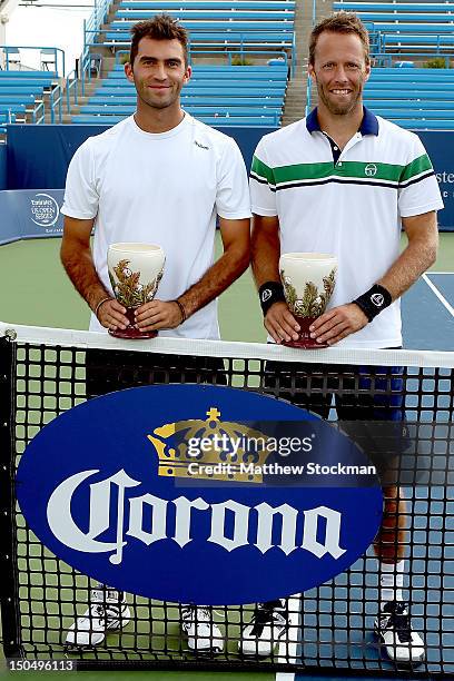 Horia Tecau of Romania and Robert Lindstedt of Sweden pose for photographers after defeating Mahesh Bhupathi and Rohan Bopanna of India during the...