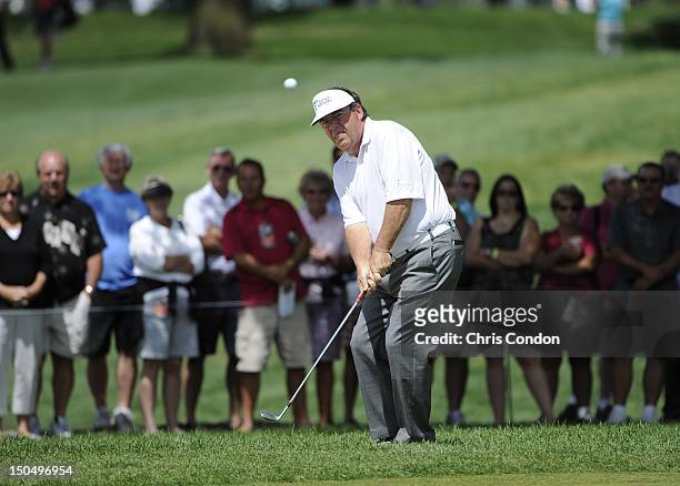 Joey Sindelar chips to the first green during the final round of the Dick’s Sporting Goods Open at En-Joie Golf Course on August 19, 2012 in...