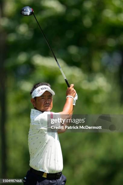 Hiroyuki Fujita of Japan stands plays his tee shot on the 14th hole during the first round of the U.S. Senior Open Championship at SentryWorld on...