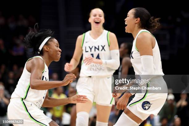 Lindsay Allen, Dorka Juhasz, Napheesa Collier of the Minnesota Lynx celebrate their 99-97 overtime win against the Seattle Storm at Climate Pledge...