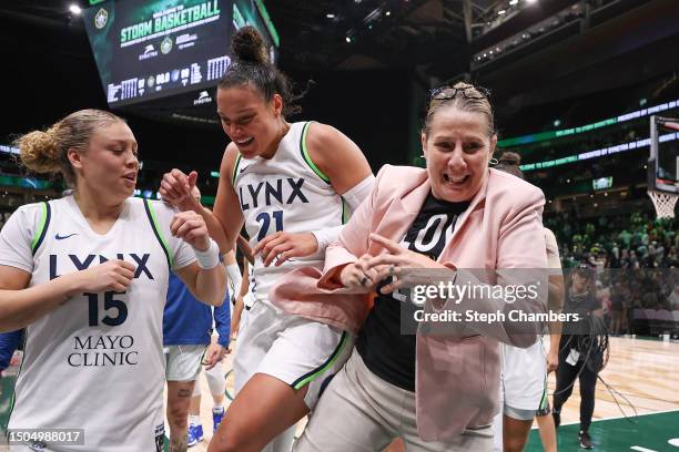 Head coach Cheryl Reeve of the Minnesota Lynx celebrates with Rachel Banham and Kayla McBride of the Minnesota Lynx their 99-97 win in overtime...