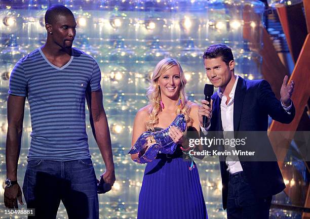 Meg Bourne accepts award from NBA player Chris Bosh and actor Jason Dundas onstage during the 2012 Do Something Awards at Barker Hangar on August 19,...