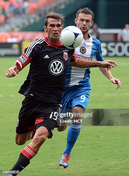 United defender Emiliano Dudar chases down a ball against Philadelphia Union forward Jack McInerney during first-half action at RFK Stadium in...