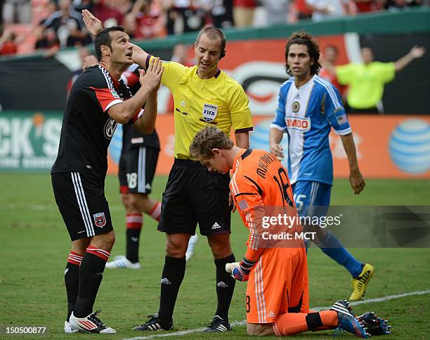 United forward Hamdi Salihi , left, pleads with referee Mark Geiger after a goal play, as Philadelphia Union goalkeeper Zac MacMath kneels on the...