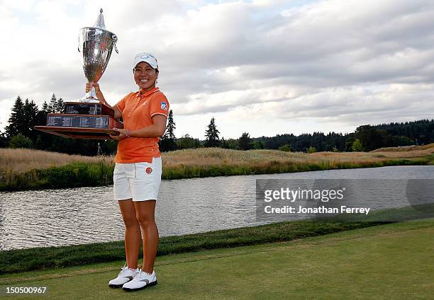Mika Miyazato of Japan poses with the trophy on the 18th hole after her 13 under par victory during the final round of the Safeway Classic at Pumpkin...
