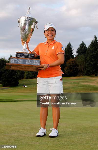 Mika Miyazato of Japan poses with the trophy on the 18th hole after her 13 under par victory during the final round of the Safeway Classic at Pumpkin...