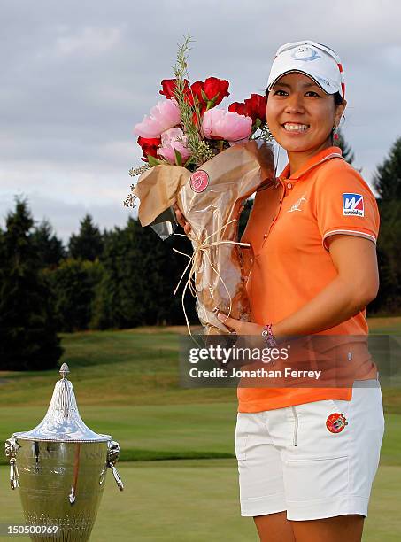 Mika Miyazato of Japan poses with the trophy on the 18th hole after her 13 under par victory during the final round of the Safeway Classic at Pumpkin...