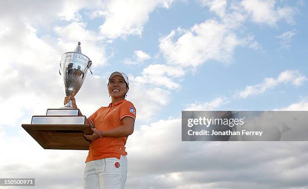 Mika Miyazato of Japan poses with the trophy on the 18th hole after her 13 under par victory during the final round of the Safeway Classic at Pumpkin...