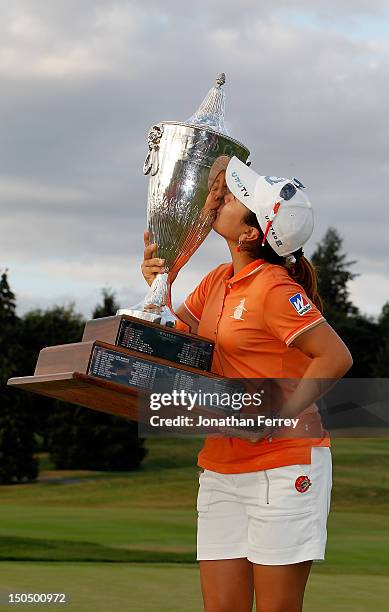 Mika Miyazato of Japan poses with the trophy on the 18th hole after her 13 under par victory during the final round of the Safeway Classic at Pumpkin...