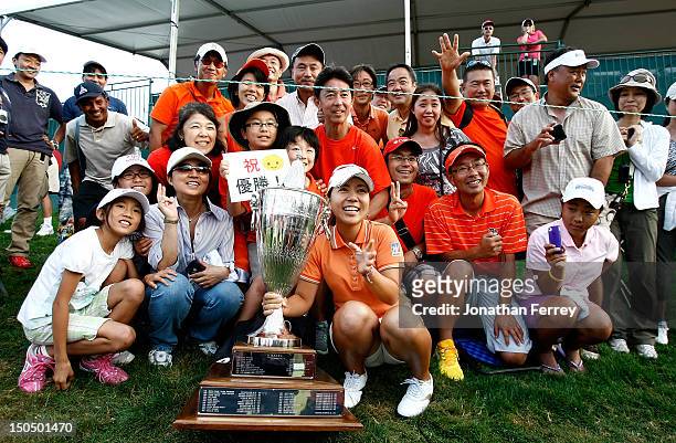 Mika Miyazato of Japan celebrates with fans on the 18th hole after her 13 under par victory during the final round of the Safeway Classic at Pumpkin...