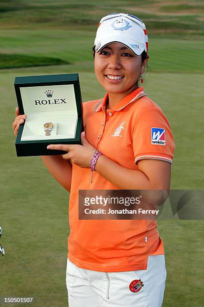 Mika Miyazato of Japan kisses poses with a Rolex watch on the 18th hole after her 13 under par victory during the final round of the Safeway Classic...
