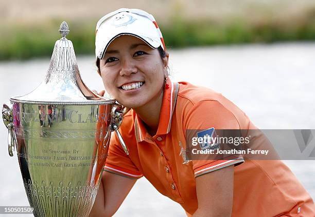 Mika Miyazato of Japan poses with the trophy on the 18th hole after her 13 under par victory during the final round of the Safeway Classic at Pumpkin...