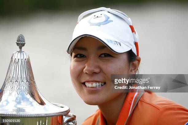 Mika Miyazato of Japan poses with the trophy on the 18th hole after her 13 under par victory during the final round of the Safeway Classic at Pumpkin...