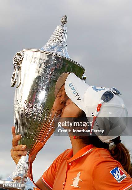 Mika Miyazato of Japan kisses the trophy on the 18th hole after her 13 under par victory during the final round of the Safeway Classic at Pumpkin...