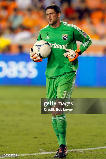 Andy Gruenebaum of the Columbus Crew comes up limping after a save against the Houston Dynamo at BBVA Compass Stadium on August 19, 2012 in Houston,...