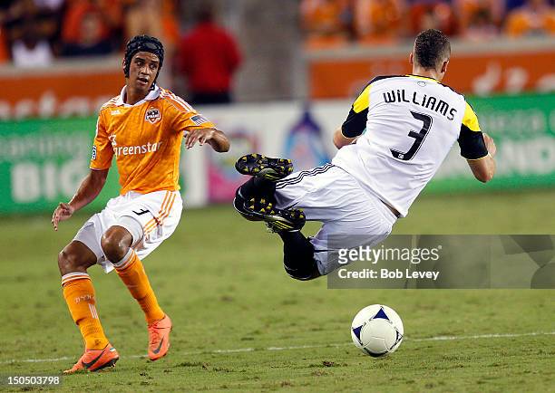 Calen Carr of the Houston Dynamo upends Josh Williams of the Columbus Crew during the second half at BBVA Compass Stadium on August 19, 2012 in...