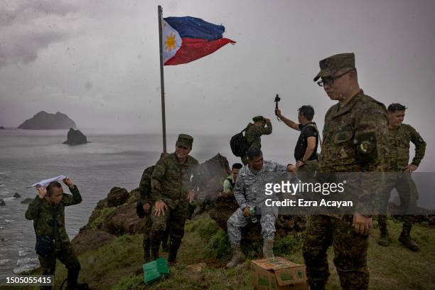 General Andres Centino , Chief of Staff of the Armed Forces of the Philippines, and Filipino soldiers take pictures next to a Philippine flag on June...