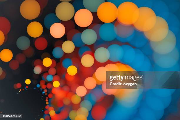 abstract gold blue yellow blured bokeh swirl circles background. christmas holiday, new year luxury pattern macro  texture - funkenflug stock-fotos und bilder