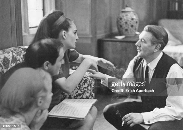 English actor and director Sir Michael Redgrave talking to operatic soprano Helia T'Hezan in the Organ Room at Glyndebourne, East Sussex, 8th May...