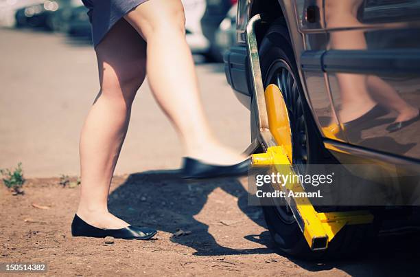 angry woman kicks wheel lock - kicking tire stock pictures, royalty-free photos & images