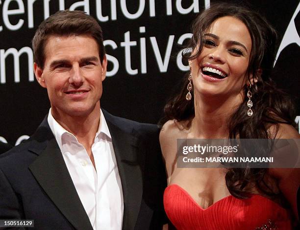 Actor Tom Cruise and actress Paula Patton arrive to the opening ceremony of the Dubai International Film Festival in the Gulf emirate on December 7,...