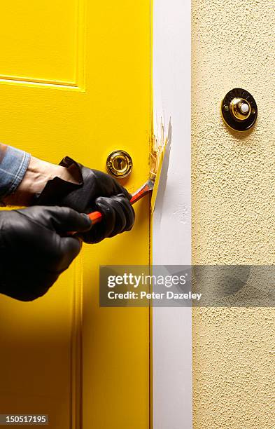 burglar breaking into the front door of a house - door stock pictures, royalty-free photos & images