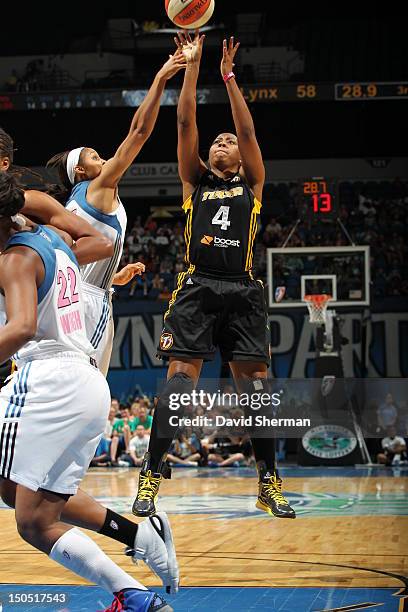 Amber Holt of the Tulsa Shock shoots the ball against Maya Moore of the Minnesota Lynx during the WNBA game on August 19, 2012 at Target Center in...