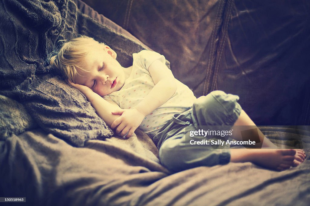 Child asleep on sofa