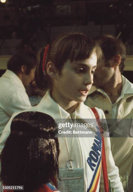 Romanian gymnast Nadia Comaneci, aged 14, speaks to the press after winning a gold medal on the balance beam at the Summer Olympics in Montreal,...