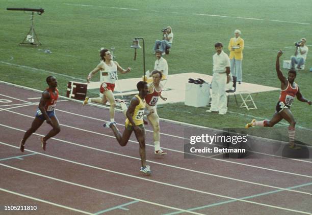 Hasely Crawford of Trinidad and Tobago waves as he crosses the finish line to win the 100 metres final at the Summer Olympics in a time of 10.06...