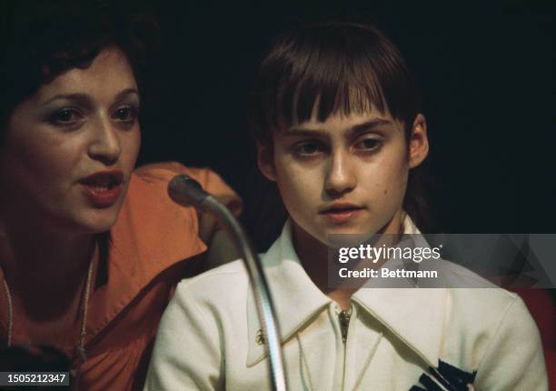Romanian gymnast Nadia Comaneci, aged 14, speaks to the press after winning a gold medal on the balance beam at the Summer Olympics in Montreal,...