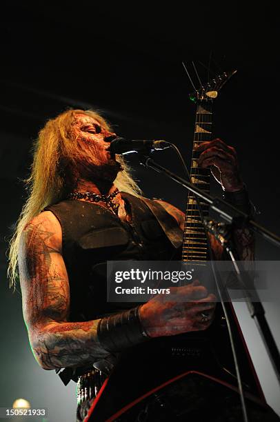 guitarrist and vocalist of metal band at club concert - heavy metal guitarist stock pictures, royalty-free photos & images