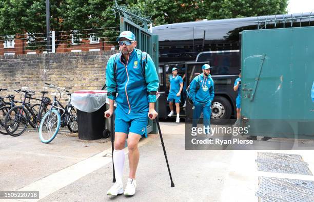 Nathan Lyon of Australia arrives on crutches after injuring his calf yesterday during Day Three of the LV= Insurance Ashes 2nd Test match between...