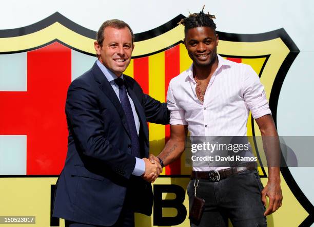 Barcelona President Sandro Rosell and Alex Song shake hands after signing for FC Barcelona at Camp Nou on August 20, 2012 in Barcelona, Spain.