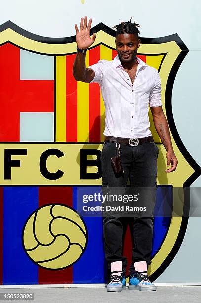 Alex Song poses for the photographers after signing for FC Barcelona at Camp Nou on August 20, 2012 in Barcelona, Spain.
