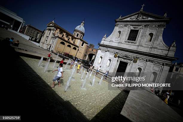 Tourists cool off in the fountain in front of the Ara Pacis monument in downtown Rome on August 20 as a heatwave hits most of Europe this week. AFP...