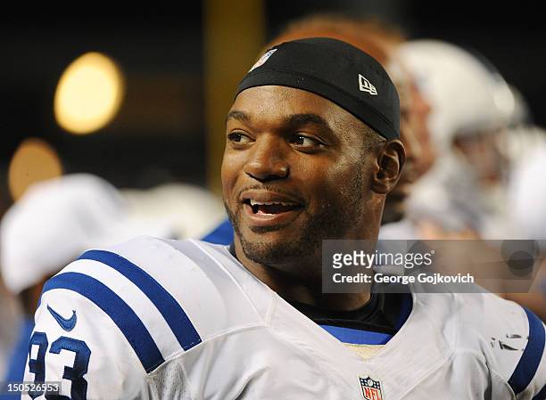 Linebacker Dwight Freeney of the Indianapolis Colts smiles as he looks on from the sideline during a preseason game against the Pittsburgh Steelers...
