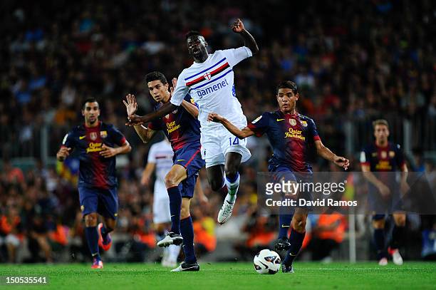 Pedro Obiang of Sampdoria duels for the ball with Marc Bartra and Jonathan Dos Santos of FC Barcelona during the Joan Gamper Trophy friendly match...