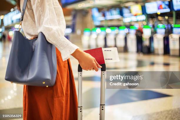 woman checking in at airport - airplane ticket stock pictures, royalty-free photos & images