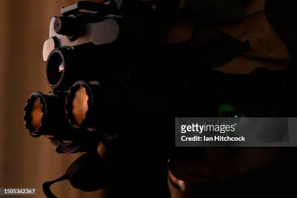 An Australian soldier is seen using night vision goggles during an urban assault on June 30, 2023 in Townsville, Australia. The exercise was held as...