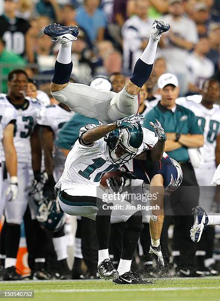 Nate Ebner of the New England Patriots tumbles over DeSean Jackson of the Philadelphia Eagles after Ebner intercepted a pass during a preseason game...