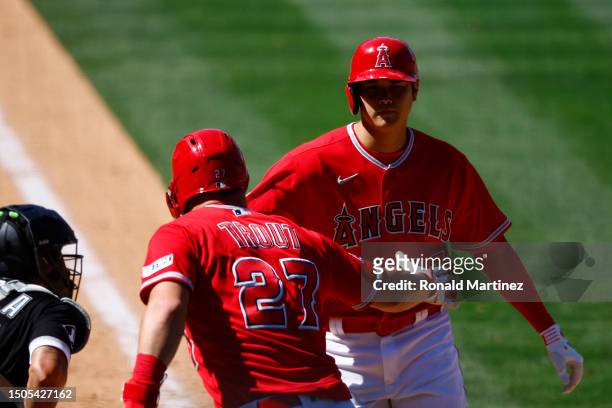 Shohei Ohtani of the Los Angeles Angels celebrates a home run with Mike Trout against the Chicago White Sox in the ninth inning at Angel Stadium of...