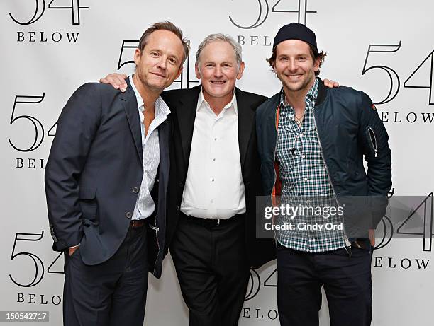 Actors John Benjamin Hickey and Bradley Cooper pose with actor Victor Garber backstage following his performance at 54 Below on August 20, 2012 in...
