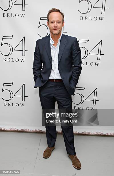 Actor John Benjamin Hickey poses backstage following Victor Garber's performance at 54 Below on August 20, 2012 in New York City.