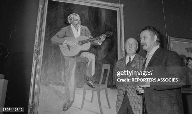 Le peintre Yves Brayer présente à Georges Brassens le portrait qu'il a fait de lui pour l'exposition 'Les Peintres témoins de leur temps' le 18...