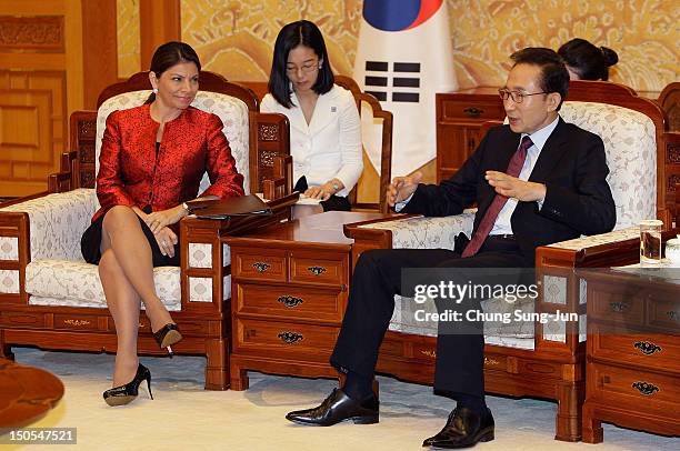 Costa Rican President Laura Chinchilla talks with South Korean President Lee Myung-Bak during their meeting at the presidential house on August 21,...