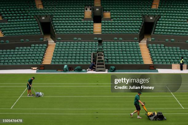 Members of ground staff prepare the court ahead of The Championships - Wimbledon 2023 at All England Lawn Tennis and Croquet Club on June 30, 2023 in...