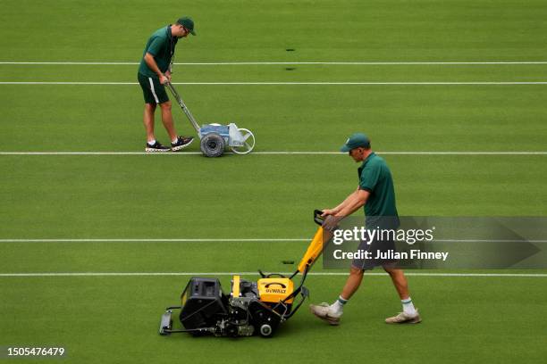 Members of ground staff prepare the court ahead of The Championships - Wimbledon 2023 at All England Lawn Tennis and Croquet Club on June 30, 2023 in...